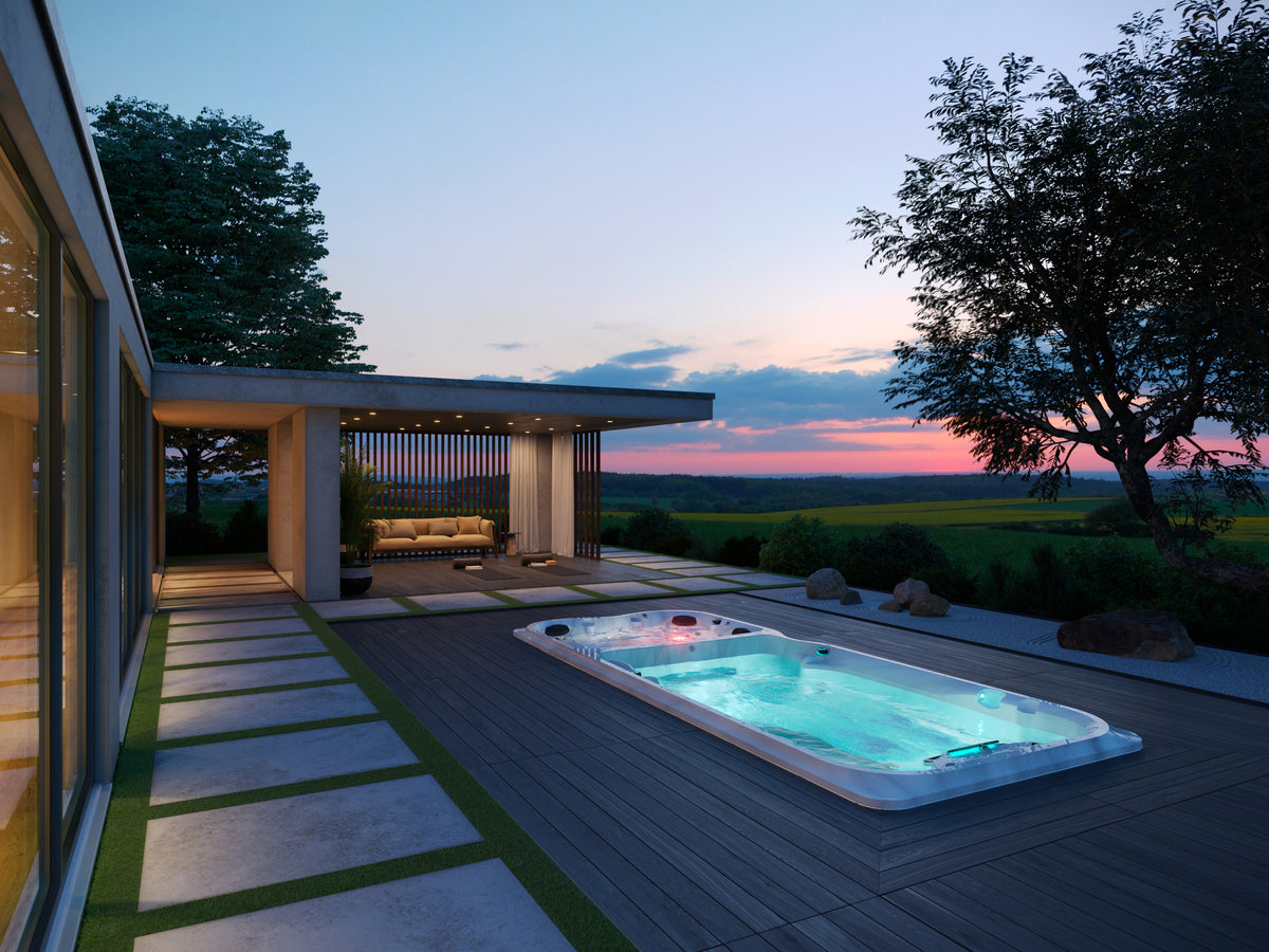 Jacuzzi® J-19DT™ PowerPro™ swim spa on a modern patio at dusk
